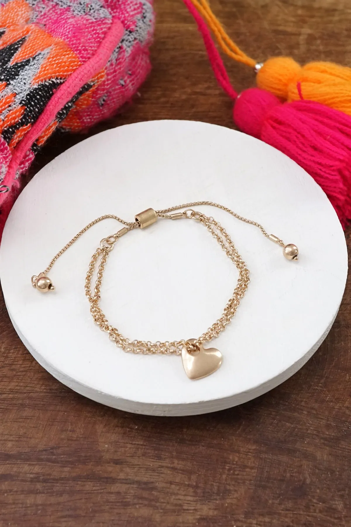 Drawstring golden chain bracelet with a heart charm