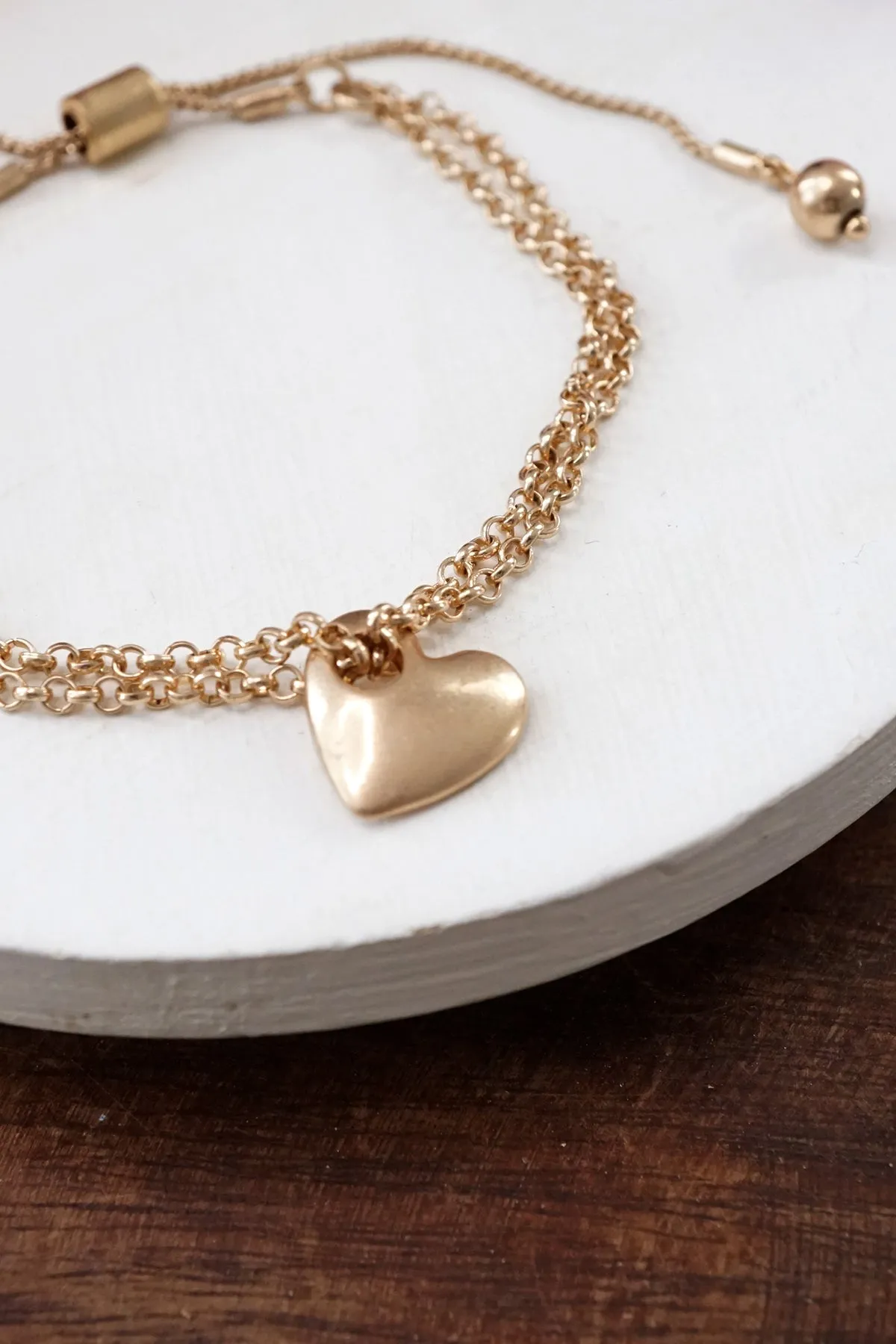 Drawstring golden chain bracelet with a heart charm